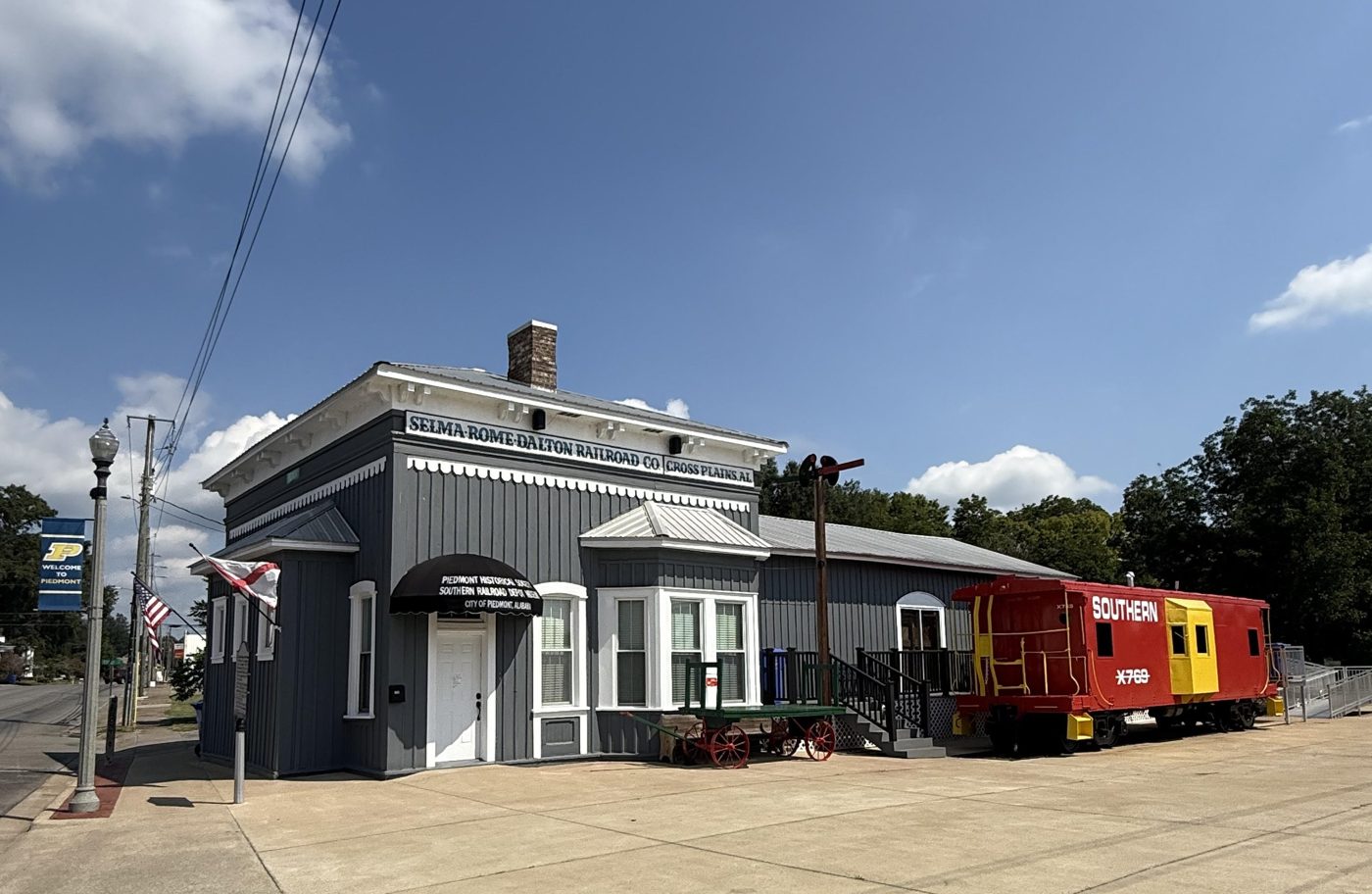The Piedmont Historical Society museum in the restored Selma-Rome-Dalton Railroad depot, with a red Southern caboose alongside