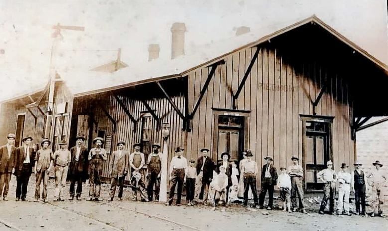 Workers gathered in front of the original wooden Piedmont railroad depot
