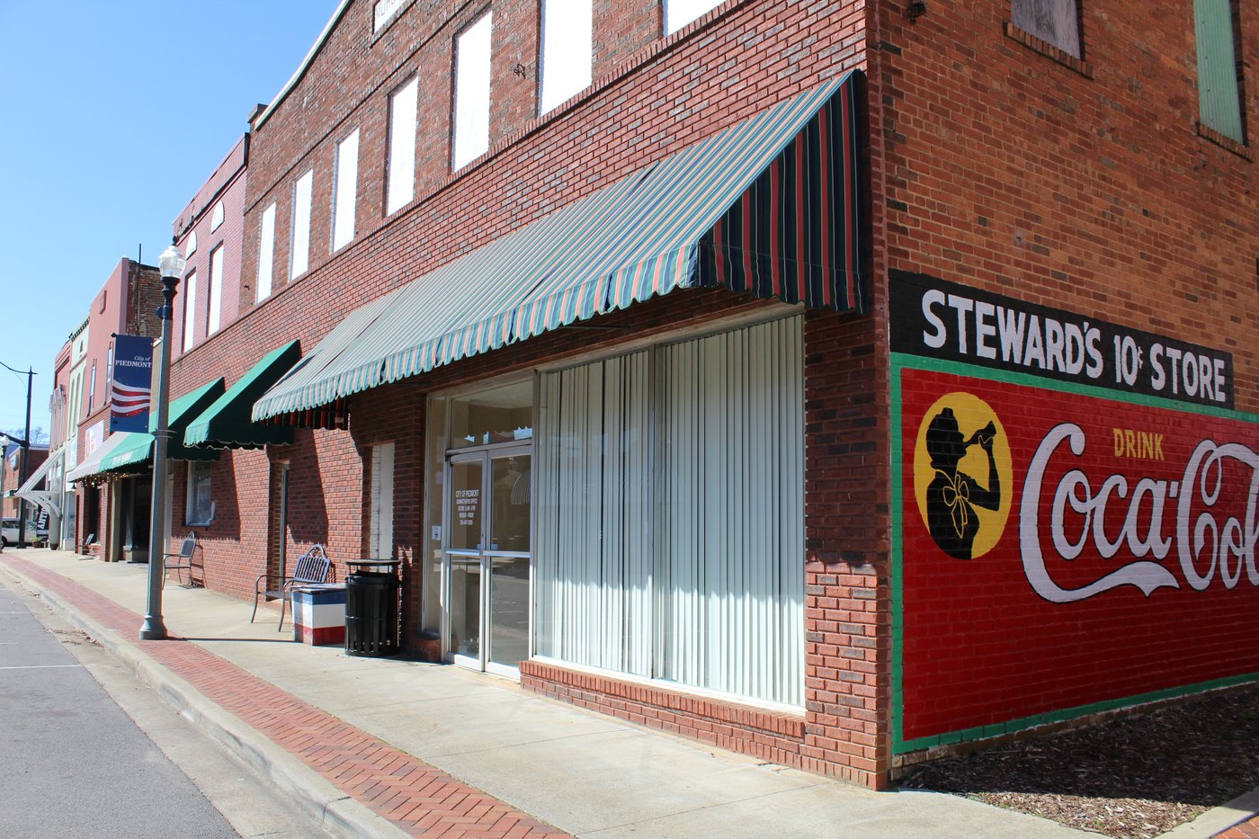 A historic downtown Piedmont storefront with a vintage Coca-Cola mural