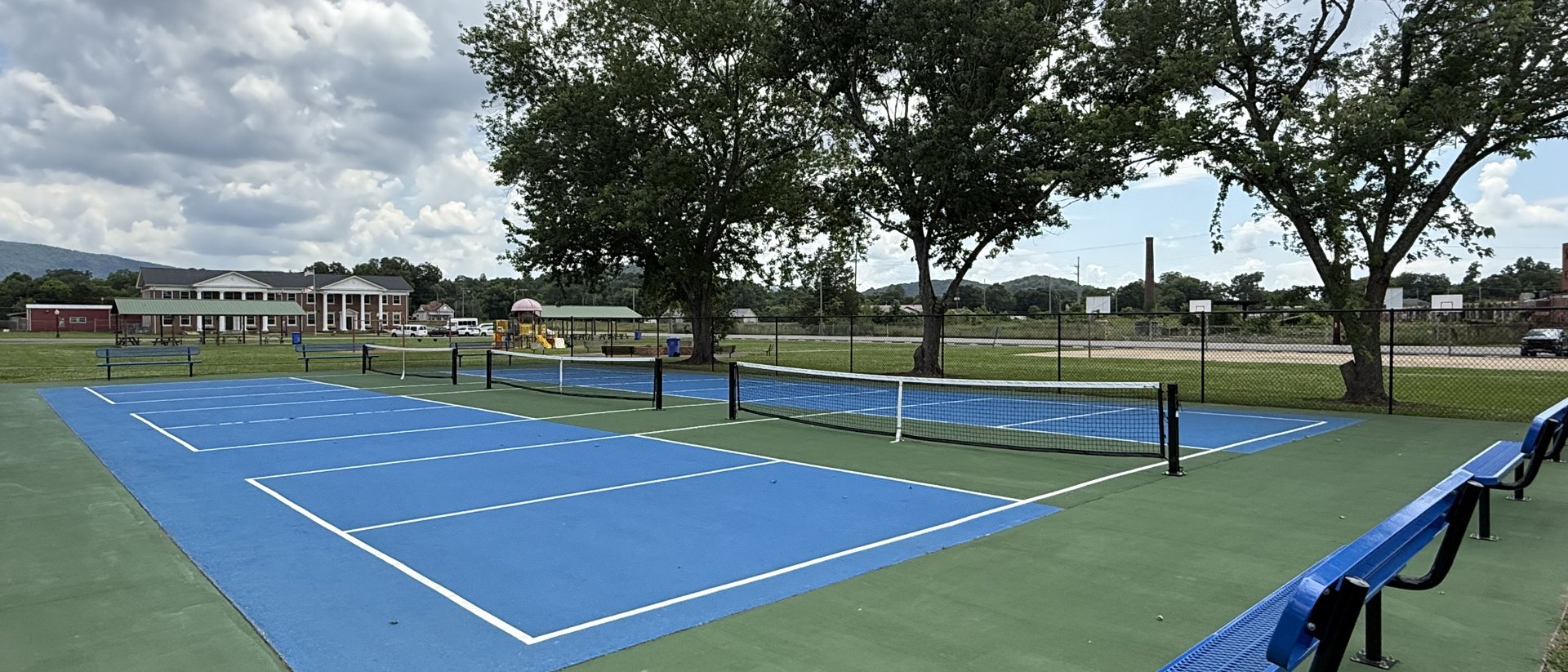 Pickleball courts at Fagan's Park in Piedmont, Alabama, with shade trees and the foothills behind